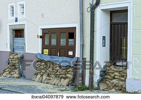 Stock Photo - Flood control measures, sandbags and a protective wall of steel slats in front of front doors and a garage door, historic centre, Passau, Lower Bavaria, Bavaria, Germany, Europe. Fotosearch