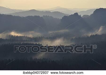 Stock Photo - Fog and haze in the morning in the Elbe Sandstone Mountains, Saxon Switzerland, Saxony, Germany, Europe. Fotosearch