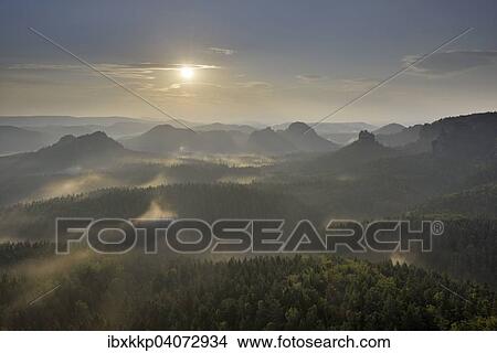 Fog at sunrise, morning atmosphere in the Elbe Sandstone Mountains, Saxon Switzerland, Saxony, Germany, Europe View Large Photo Image Picture - Fog at sunrise, morning atmosphere in the Elbe Sandstone Mountains, Saxon Switzerland, Saxony, Germany, Europe. Fotosearch