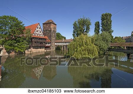 Stock Image - Former Weinstadl, 1446-48 built as a special infirmary, former water tower right, Maxbrucke left, Pegnitz in front, Nuremberg, Middle Franconia, Bavaria, Germany, Europe. Fotosearch