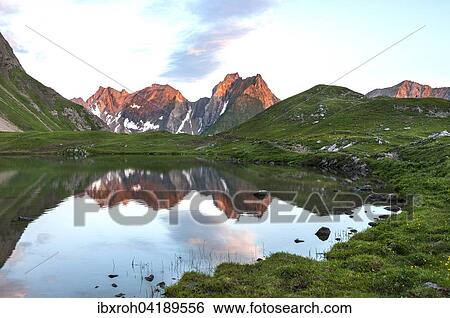 Stock Photograph - Freispitze mountain reflected in the Unterer Seewiesee lake, mountain panorama in the morning light, Lechtal Alps, Tyrol, Austria, Europe. Fotosearch