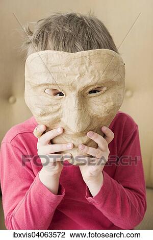 Girl hiding face behind mask View Large Photo Image Stock Image - Girl hiding face behind mask. Fotosearch