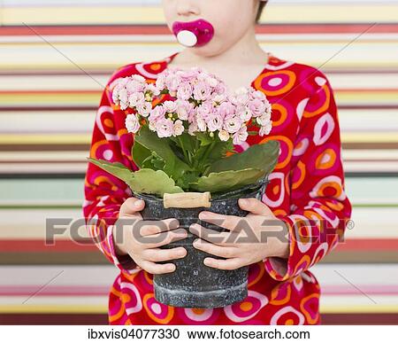 Girl holding flower in flowerpot View Large Photo Image Stock Image - Girl holding flower in flowerpot. Fotosearch