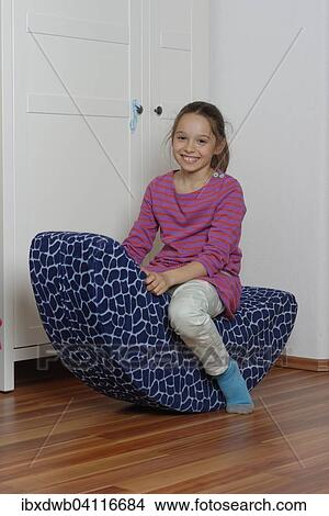 Girl on a child's rocking chair, play room, Germany, Europe View Large Photo Image Picture - Girl on a child's rocking chair, play room, Germany, Europe. Fotosearch