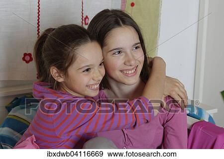 Girls, sisters hugging, Germany, Europe View Large Photo Image Stock Photo - Girls, sisters hugging, Germany, Europe. Fotosearch