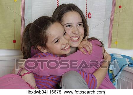 Stock Photo - Girls, sisters hugging, Germany, Europe. Fotosearch