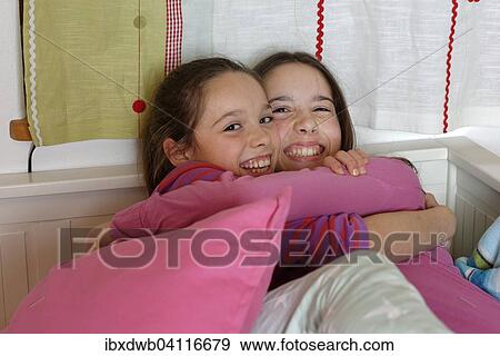 Girls, sisters hugging, Germany, Europe View Large Photo Image Stock Photo - Girls, sisters hugging, Germany, Europe. Fotosearch