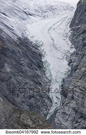 Stock Image - Glacier tongue and rugged rock structures, Kaiser Franz Josef Fjord, Kejser Franz Josef Fjord, Northeast Greenland National Park, Greenland, North America. Fotosearch