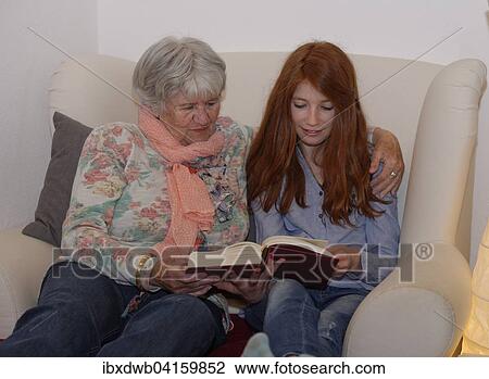 Granddaughter and grandmother reading a book together, Bavaria, Germany, Europe View Large Photo Image Stock Image - Granddaughter and grandmother reading a book together, Bavaria, Germany, Europe. Fotosearch