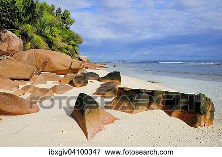Stock Photo - Granite rocks on the sandy beach beach, La Digue, Seychelles, Africa. Fotosearch