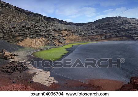 Green lagoon, Lago Verde, volcanic lake coloured green from algae, lava beach, Charco de los Clicos, caldera of El Golfo, Lanzarote, Canary Islands, Spain, Europe View Large Photo Image Picture - Green lagoon, Lago Verde, volcanic lake coloured green from algae, lava beach, Charco de los Clicos, caldera of El Golfo, Lanzarote, Canary Islands, Spain, Europe. Fotosearch