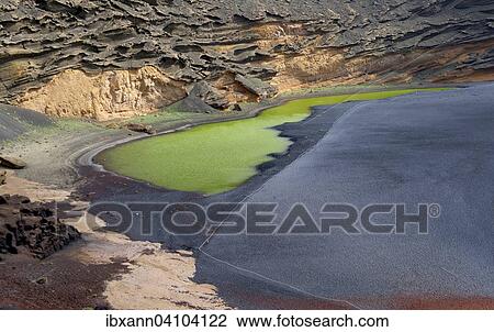 Stock Image - Green lagoon, Lago Verde, volcanic lava, Charco de los Clicos, caldera of El Golfo, Lanzarote, Canary Islands, Spain, Europe. Fotosearch