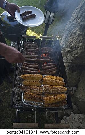 Stock Image - Grill with sausages and corn on the cob, Germany, Europe. Fotosearch
