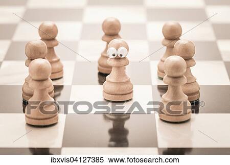 Stock Photography - Group of chess pieces, one with eyes. Fotosearch