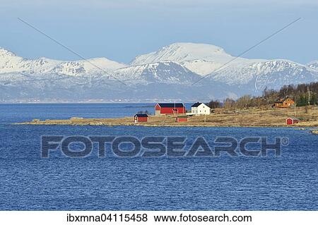 Stock Photo - Headland with houses in the blue water of Hadselfjord and Raftsund, Vesteralen, Nordland, Norway, Europe. Fotosearch