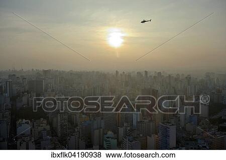 Helicopter above a cityscape with skyscrapers at sunset, Sao Paulo, Brazil, South America View Large Photo Image Stock Photo - Helicopter above a cityscape with skyscrapers at sunset, Sao Paulo, Brazil, South America. Fotosearch