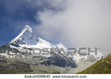 Stock Image - Hiker on the Hohbalmen trail, behind the Matterhorn, Zermatt, Canton of Valais, Switzerland, Europe. Fotosearch