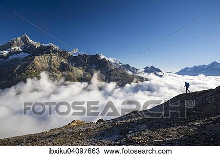 Stock Image - Hiker on the trail to the Hornli hut, Zermatt, Canton of Valais, Switzerland, Europe. Fotosearch
