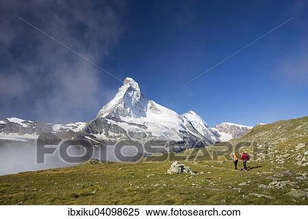 Stock Photography - Hikers on the Hohbalmen trail, the Matterhorn at the back, Zermatt, Canton of Valais, Switzerland, Europe. Fotosearch