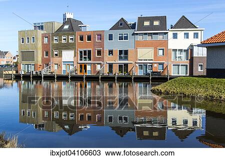 Stock Image - Houses by the water, new buildings in the district Nieuw Den Helder, North Holland, The Netherlands, Europe. Fotosearch