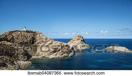 Stock Photography - Ile de la Pietra with lighthouse at the tip of L'Ile-Rousse, Haute-Corse, Corsica, France, Europe. Fotosearch