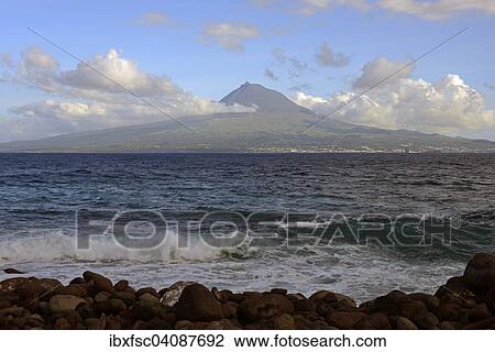 Stock Image - Island and Mt Pico, Porto da Boca da Ribeira, Ponta da Ribeirinha, Faial, Azores, Portugal, Europe. Fotosearch