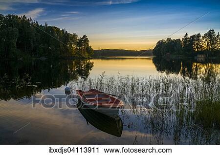 Lake and rowing boat at sunset in Bengtsfors, Dalsland, Sweden, Europe View Large Photo Image Stock Image - Lake and rowing boat at sunset in Bengtsfors, Dalsland, Sweden, Europe. Fotosearch