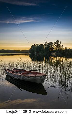 Lake and rowing boat at sunset in Bengtsfors, Dalsland, Sweden, Europe View Large Photo Image Stock Image - Lake and rowing boat at sunset in Bengtsfors, Dalsland, Sweden, Europe. Fotosearch