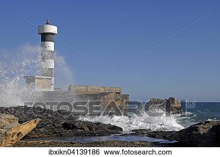 Stock Photograph - Lighthouse, surf, Colonia de Sant Jordi, Majorca, Balearic Islands, Spain, Europe. Fotosearch