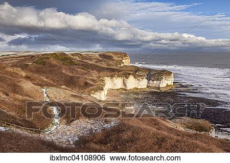 Stock Photograph - Limestone cliffs at Flamborough Head in winter, light sprinkle of snow on the ground, Flamborough Head, East Yorkshire, England, United Kingdom, Europe. Fotosearch