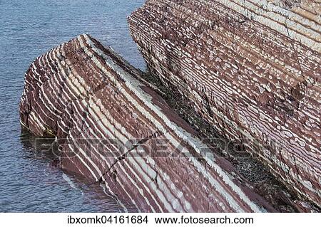 Picture - Limestone coloured red by iron and whitish-yellow dolomite, Segelsallskapet Fjord, Northeast Greenland National Park, Greenland, North America. Fotosearch