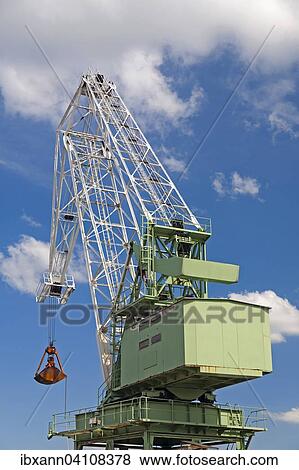 Loading crane, green and white, blue sky with clouds View Large Photo Image Stock Photo - Loading crane, green and white, blue sky with clouds. Fotosearch