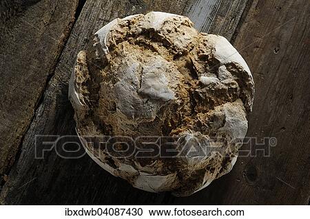 Loaf of bread on a wooden board View Large Photo Image Stock Image - Loaf of bread on a wooden board. Fotosearch