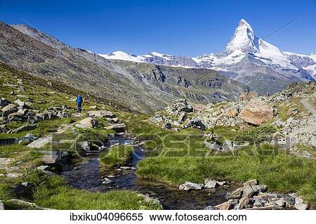 Man hiking, at Fluhalp, the Matterhorn at the back, Zermatt, Canton of Valais, Switzerland, Europe View Large Photo Image Stock Photography - Man hiking, at Fluhalp, the Matterhorn at the back, Zermatt, Canton of Valais, Switzerland, Europe. Fotosearch