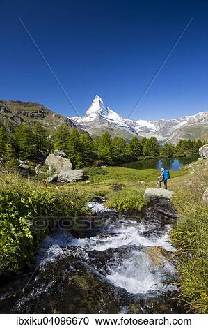 Man hiking at Grindjisee lake, the Matterhorn at the back, Zermatt, Canton of Valais, Switzerland, Europe View Large Photo Image Stock Image - Man hiking at Grindjisee lake, the Matterhorn at the back, Zermatt, Canton of Valais, Switzerland, Europe. Fotosearch