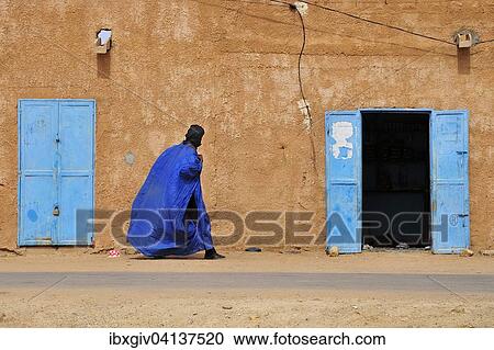 Man wearing traditional clothes, Derra'a or Boubou, by a mud house with a painted blue door, Atar, Adrar Province, Mauritania, Africa View Large Photo Image Stock Image - Man wearing traditional clothes, Derra'a or Boubou, by a mud house with a painted blue door, Atar, Adrar Province, Mauritania, Africa. Fotosearch