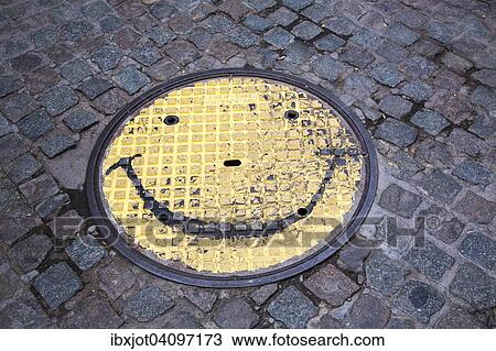 Stock Image - Manhole cover with smiley face, North Rhine-Westphalia, Germany, Europe. Fotosearch