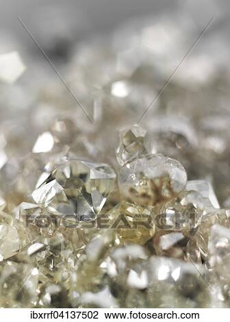 Stock Image - Many valuable diamonds, raw and cut, for further processing for the jewelery industry. Fotosearch