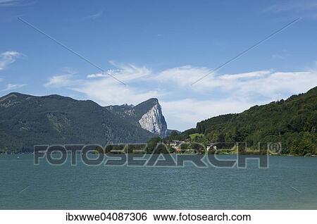 Stock Photograph - Mondsee lake with Drachenwand rock wall at the back, Salzkammergut, Upper Austria, Austria, Europe. Fotosearch