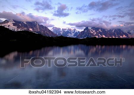 Mont Blanc massif in the evening light reflected in Lac de Chesserys, Aiguilles de Chamonix on the left, Chamonix, France, Europe View Large Photo Image Picture - Mont Blanc massif in the evening light reflected in Lac de Chesserys, Aiguilles de Chamonix on the left, Chamonix, France, Europe. Fotosearch