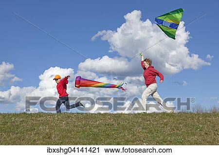 Mother and son flying a kite and a windsock, Germany, Europe View Large Photo Image Stock Image - Mother and son flying a kite and a windsock, Germany, Europe. Fotosearch