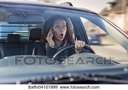 Motorist without a seat belt making a call on a mobile phone, Germany, Europe View Large Photo Image Stock Photo - Motorist without a seat belt making a call on a mobile phone, Germany, Europe. Fotosearch