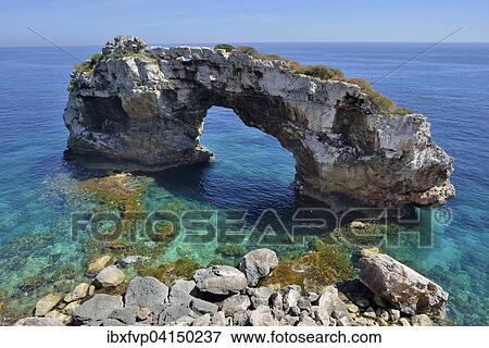 Natural arch Es Pontas, near Cala Llombards, Majorca, Balearic Islands, Spain, Europe View Large Photo Image Stock Photo - Natural arch Es Pontas, near Cala Llombards, Majorca, Balearic Islands, Spain, Europe. Fotosearch