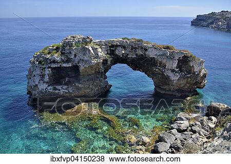 Stock Photo - Natural arch Es Pontas, near Cala Llombards, Majorca, Balearic Islands, Spain, Europe. Fotosearch