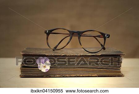 Old book with reading glasses and a horned violet View Large Photo Image Stock Photography - Old book with reading glasses and a horned violet. Fotosearch
