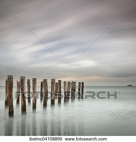 Old jetty posts on the beach at St Clair, Dunedin, Otago, New Zealand, Oceania View Large Photo Image Stock Photography - Old jetty posts on the beach at St Clair, Dunedin, Otago, New Zealand, Oceania. Fotosearch