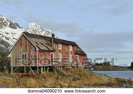 Stock Image - Old wooden house on the seashore, Henningsvaer, Lofoten, Nordland, Norway, Europe. Fotosearch