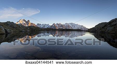 Stock Image - Panorama of Mont Blanc massif with reflection in the Lac des Chesery, evening, Chamonix, Rhone-Alpes, France, Europe. Fotosearch