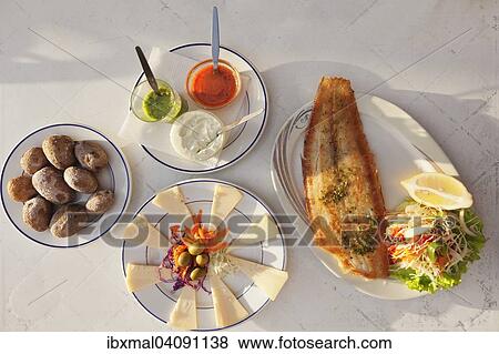 Stock Photo - Papas arrugadas con mojo, wrinkled potatoes with mojo sauce, fried fish and cheese platter with Canarian cheese, La Gomera, Canary Islands, Spain, Europe. Fotosearch