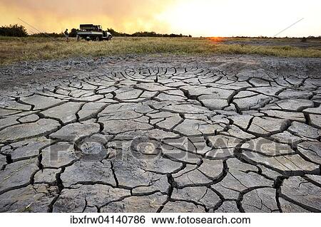 Parched water pond, safari vehicle behind, sunset, South Luangwa National Park, Zambia, Africa View Large Photo Image Stock Photograph - Parched water pond, safari vehicle behind, sunset, South Luangwa National Park, Zambia, Africa. Fotosearch